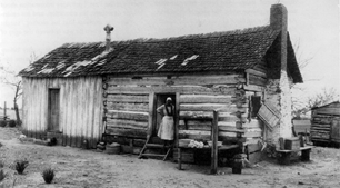 American Slaves: Slave Woman at Cabin American slave woman standing in doorway of slave cabin